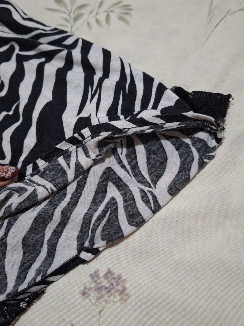 Y2k Zebra Print Layered Mesh Top (Category: Blouses) located in Taguig. Submitted by butterflypea.thrift (Listing ID 1460967292, Image 3). Description: - Eye-catching black and white zebra print - Unique layered mesh and lace design - Sleeveless with a flattering scoop neckline - Estimated size: Small to Medium - size: bust - 30 , length - 36 - Ideal for a stylish night out or as a statement piece.
