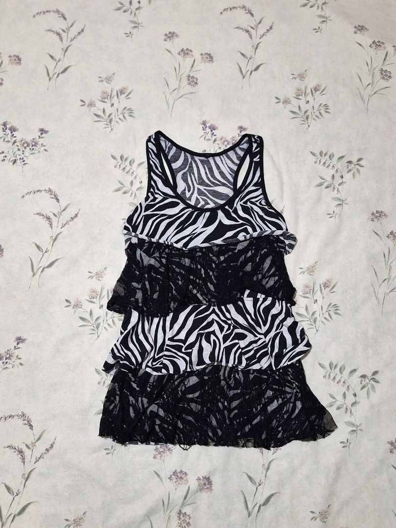 Y2k Zebra Print Layered Mesh Top (Category: Blouses) located in Taguig. Submitted by butterflypea.thrift (Listing ID 1460967292, Image 1). Description: - Eye-catching black and white zebra print - Unique layered mesh and lace design - Sleeveless with a flattering scoop neckline - Estimated size: Small to Medium - size: bust - 30 , length - 36 - Ideal for a stylish night out or as a statement piece.