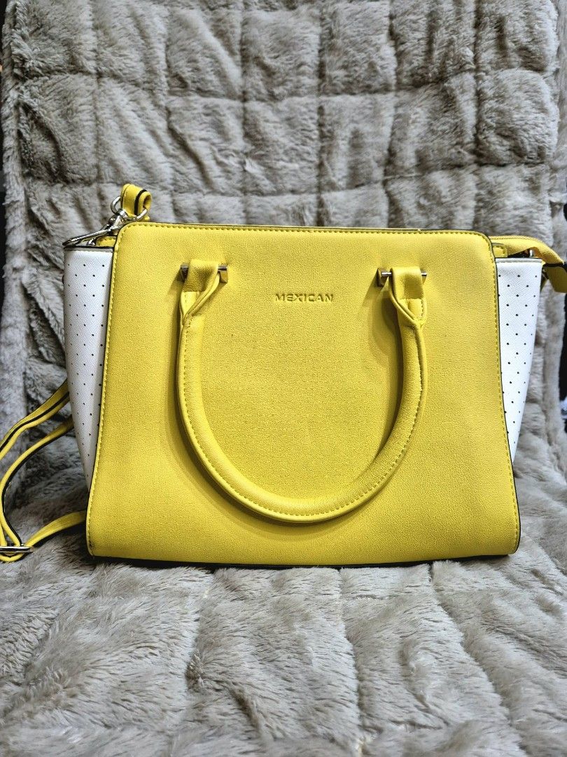 Yellow and White Mexican Handbag (Category: Tote Bags) located in Manila. Submitted by mysticfox.9b1678 (Listing ID 1461018970, Image 1). Description: - Adorable yellow handbag with stylish white perforated sides. - Features a comfortable top handle and a versatile detachable shoulder strap. - Subtle 'MEXICAN' brand name embossed on the front. - Ample interior space for all your daily essentials. - Perfect for everyday use or adding a vibrant pop