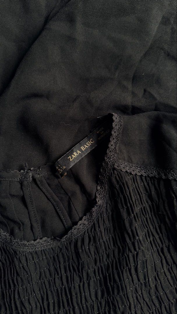 Zara Basic Black Long Sleeve Smocked Blouse (Category: Blouses) located in General Santos City (Dadiangas). Submitted by ssssshhhhhhhhh (Listing ID 1460949849, Image 3). Description: - Zara Basic black long sleeve blouse - Smocking detail on the front - Lace trim along neckline and hem - Button closure at the back of the neck - Lightweight fabric - Made in Morocco.