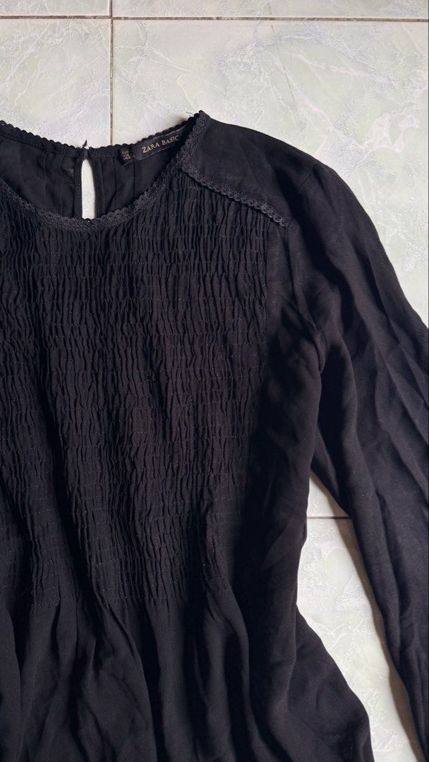 Zara Basic Black Long Sleeve Smocked Blouse (Category: Blouses) located in General Santos City (Dadiangas). Submitted by ssssshhhhhhhhh (Listing ID 1460949849, Image 2). Description: - Zara Basic black long sleeve blouse - Smocking detail on the front - Lace trim along neckline and hem - Button closure at the back of the neck - Lightweight fabric - Made in Morocco.