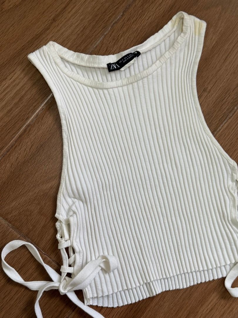 Zara Basic Ribbed Side Lace Up Crop Top in White (Category: Sleeveless) located in Calamba. Submitted by shop.ysha (Listing ID 1461046209, Image 2). Description: such a wardrobe staple ! basic crop tee to pair with jeans or a cute skirt ! Size: SMALL Issue: has a stain pls see photo (washable need to laundry) ‼️ all items are available unless marked sold ‼️ loc: Calamba, Laguna (Nuvali) ‼️ if you like it, buy it asap or you’ll regret it ! my clot