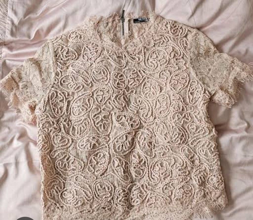 Zara Lace Top (Category: Blouses) located in Tarlac. Submitted by momma02 (Listing ID 1460935935, Image 1). Description: - Beige crop lace top - Short sleeves - High neckline - Back zip closure - Intricate lace pattern - Delicate fringe detail on hem and sleeves - Perfect for dressing up or down.