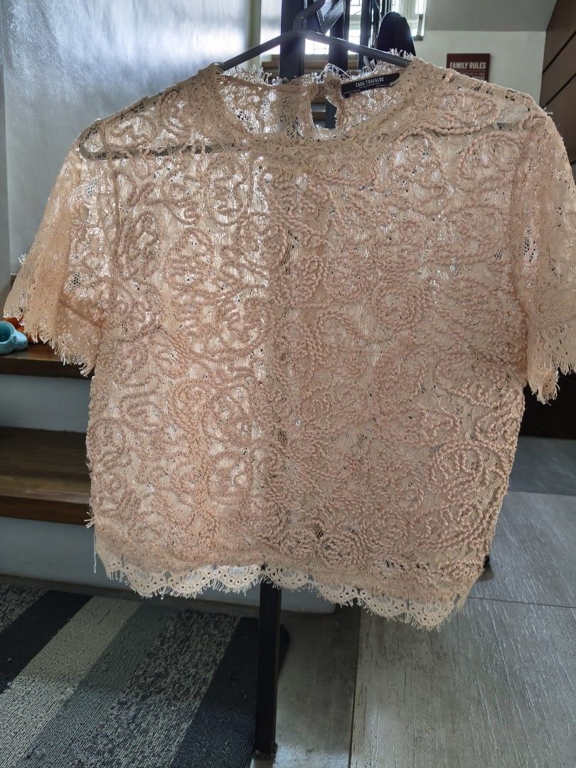 Zara Lace Top (Category: Blouses) located in Tarlac. Submitted by momma02 (Listing ID 1460935935, Image 2). Description: - Beige crop lace top - Short sleeves - High neckline - Back zip closure - Intricate lace pattern - Delicate fringe detail on hem and sleeves - Perfect for dressing up or down.