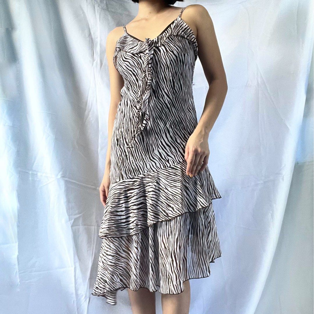 Zebra Print Ruffle Tiered Mini Dress Spaghetti Straps (Category: Dresses) located in Manila. Submitted by demi.rewears (Listing ID 1461068518, Image 1). Description: Cute zebra print mini dress with spaghetti straps and a tie-front. Features ruffled tiers for a flirty look. Lightweight and versatile for any occasion. Size: Fits Small to Semi-Medium Bust: Fits 30” to 32” (15.5” flat lay) Waist: Fits 24” to 26” (12” flat lay) Length: 36.5” (Midi / 