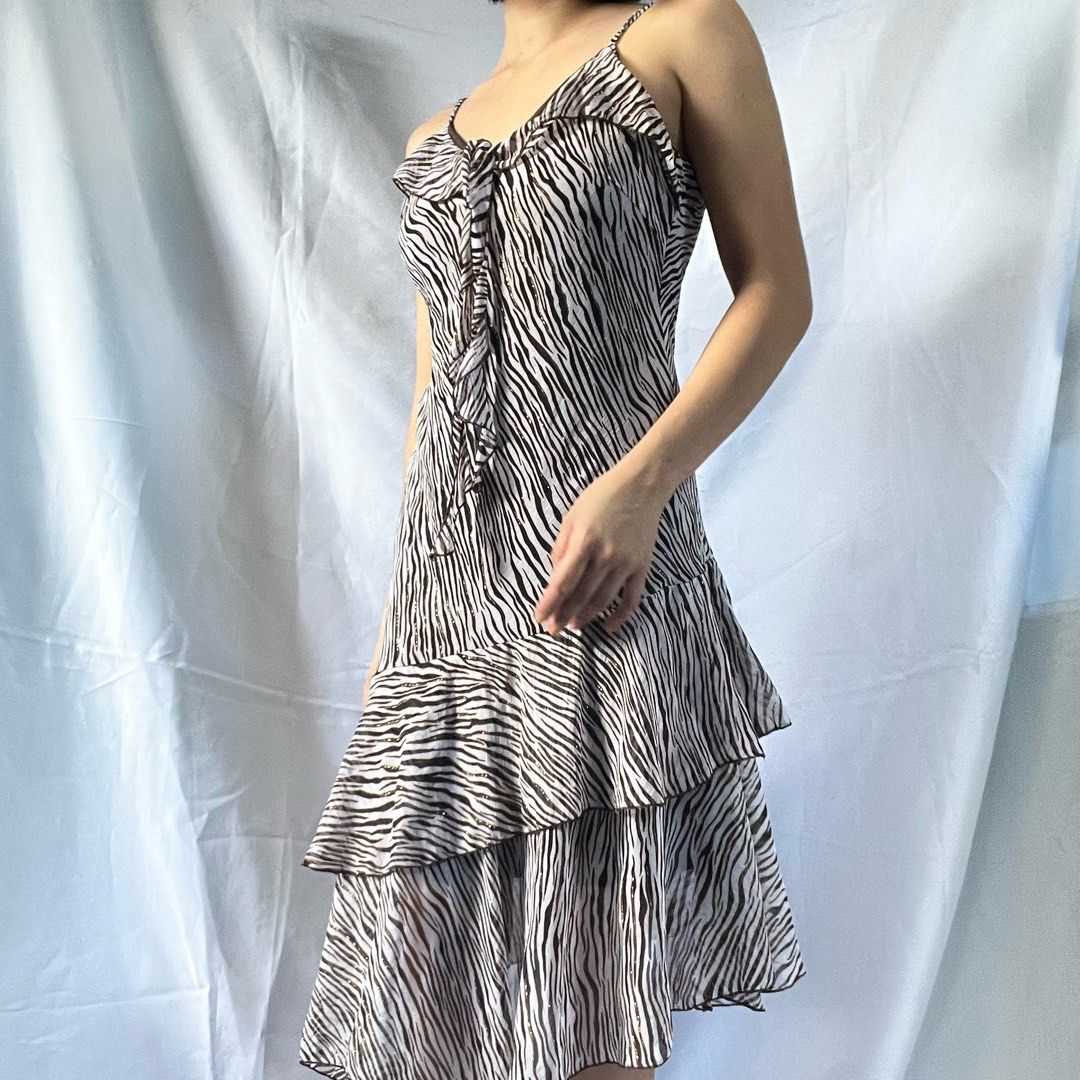 Zebra Print Ruffle Tiered Mini Dress Spaghetti Straps (Category: Dresses) located in Manila. Submitted by demi.rewears (Listing ID 1461068518, Image 2). Description: Cute zebra print mini dress with spaghetti straps and a tie-front. Features ruffled tiers for a flirty look. Lightweight and versatile for any occasion. Size: Fits Small to Semi-Medium Bust: Fits 30” to 32” (15.5” flat lay) Waist: Fits 24” to 26” (12” flat lay) Length: 36.5” (Midi / 