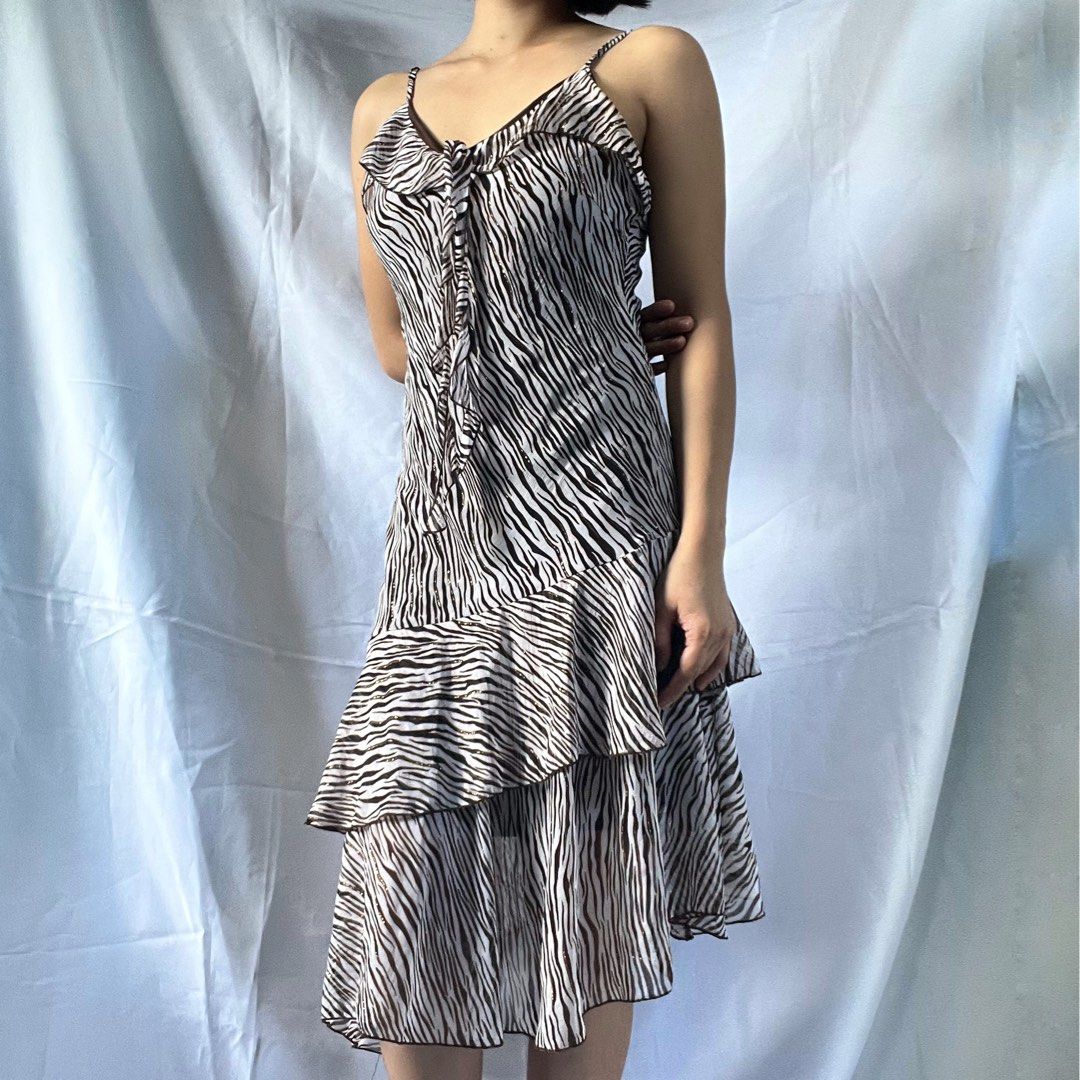Zebra Print Ruffle Tiered Mini Dress Spaghetti Straps (Category: Dresses) located in Manila. Submitted by demi.rewears (Listing ID 1461068518, Image 3). Description: Cute zebra print mini dress with spaghetti straps and a tie-front. Features ruffled tiers for a flirty look. Lightweight and versatile for any occasion. Size: Fits Small to Semi-Medium Bust: Fits 30” to 32” (15.5” flat lay) Waist: Fits 24” to 26” (12” flat lay) Length: 36.5” (Midi / 