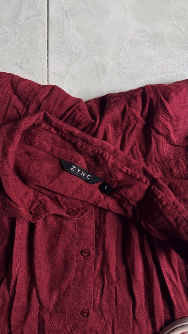 ZYNC Red Button-Up Shirt with Sequins - Size L (Category: Shirts) located in General Santos City (Dadiangas). Submitted by ssssshhhhhhhhh (Listing ID 1460949761, Image 3). Description: - ZYNC red long-sleeved shirt - Collared neckline with button-up front - Purple embroidery with sequins on chest - Textured fabric - Size: L.