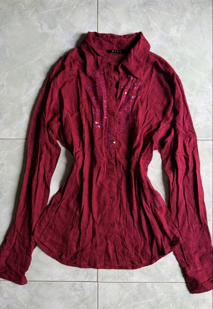ZYNC Red Button-Up Shirt with Sequins - Size L (Category: Shirts) located in General Santos City (Dadiangas). Submitted by ssssshhhhhhhhh (Listing ID 1460949761, Image 1). Description: - ZYNC red long-sleeved shirt - Collared neckline with button-up front - Purple embroidery with sequins on chest - Textured fabric - Size: L.