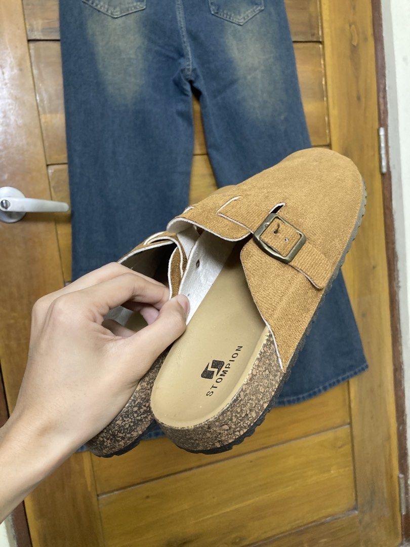 ₱150 + SF via JNT (Category: Slippers & Slides) located in Batangas. Submitted by declutteringvon (Listing ID 1461300935, Image 2). Description: - Brand: STOMPION - Material: Brown Suede - Sole: Cork - Features: Adjustable strap with buckle - Size: 42-43 - Style: Casual, easy slip-on/off.