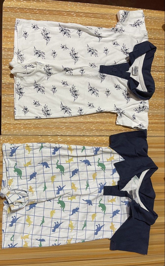 2x Baby Rompers - Leaf & Dinosaur Prints (Category: Babies & Kids Fashion) located in Manila. Submitted by chogarcookie (Listing ID 1461204998, Image 1). Description: - Set of two adorable baby rompers. - Romper 1: White base with navy collar and delicate leaf print. - Romper 2: White base with navy collar and fun dinosaur grid pattern (blue, yellow, green). - Both feature short sleeves for comfort. - Easy snap closures for quick dressing. - Idea