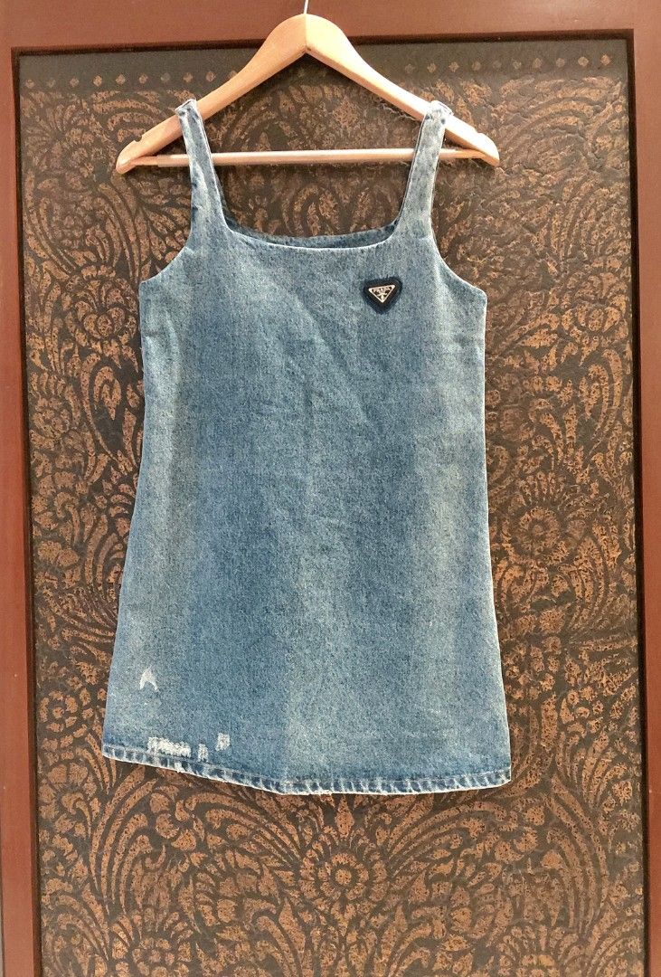 💯 PRADA DENIM DRESS (Category: Dresses) located in Mandaluyong City. Submitted by arlene2560 (Listing ID 1461248247, Image 1). Description: 💯 Authentic blue denim mini dress by PRADA featuring the brand's signature triangular logo plaque on the chest. Small on tag, armpit 17", length 32". Decluttering P2500. Mandaluyong.