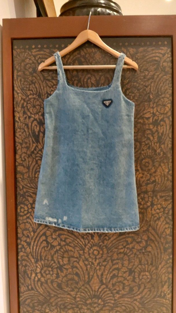 💯 PRADA DENIM DRESS (Category: Dresses) located in Mandaluyong City. Submitted by arlene2560 (Listing ID 1461248247, Image 3). Description: 💯 Authentic blue denim mini dress by PRADA featuring the brand's signature triangular logo plaque on the chest. Small on tag, armpit 17", length 32". Decluttering P2500. Mandaluyong.