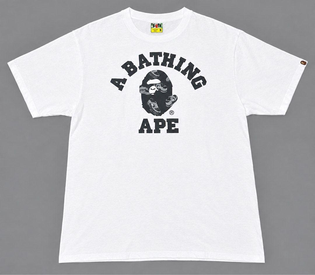 A Bathing Ape White T-Shirt Size M (Category: Tshirts & Polo Shirts ) located in Manila. Submitted by jkm_g (Listing ID 1461272312, Image 1). Description: - White A Bathing Ape (BAPE) T-shirt - Features the iconic ape head logo with sneakers graphic - Size: Medium (M) - Ideal for streetwear fashion - Versatile: pairs well with jeans or shorts - A must-have iconic piece.