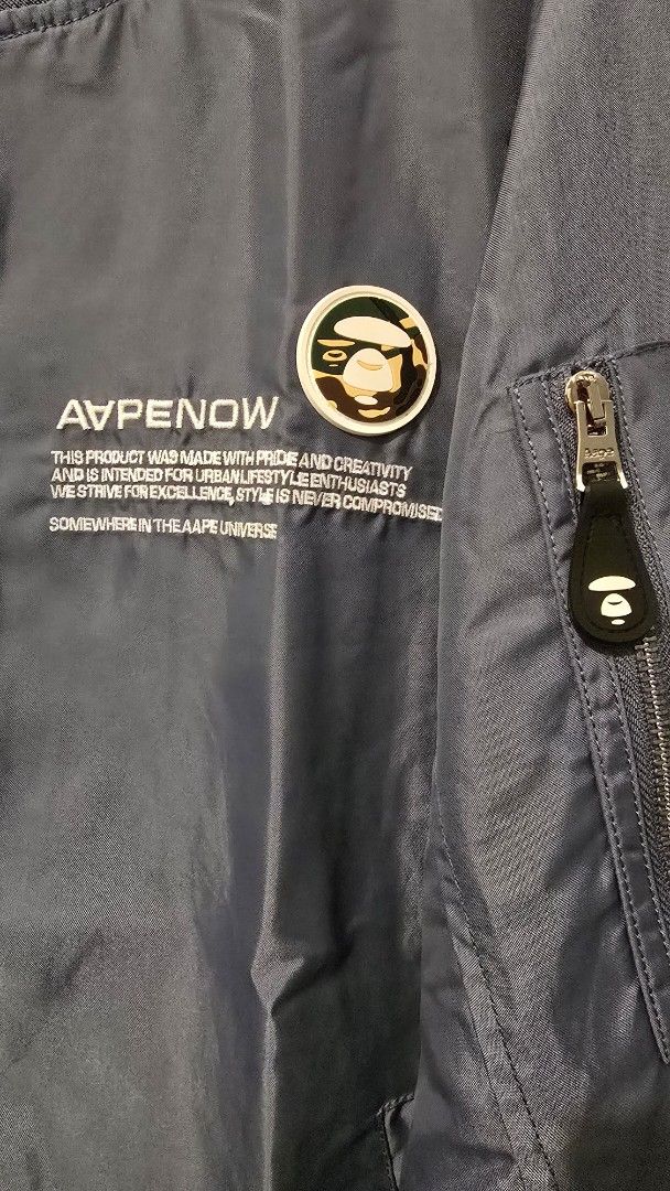 AAPE NOW Bomber Jacket (Category: Coats, Jackets and Outerwear) located in Quezon City. Submitted by ShoesManila (Listing ID 1461282153, Image 2). Description: AAPE Jacket Width 22 Length 27 Arm Length 27 Condition: Excellent Color rate: 10/10 - Grey AAPE NOW bomber jacket - Features AAPE NOW logo and text graphic on the front - Zipper closure - Convenient sleeve pocket - Ribbed collar, cuffs, and hem Ready to ship No COD Location: Diliman, QC.