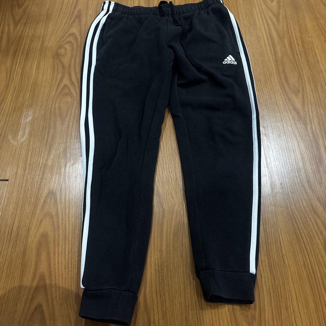 Adidas Black Joggers with White Stripes (Category: Other Bottoms) located in Quezon City. Submitted by murafindsph (Listing ID 1461299309, Image 1). Description: - Classic black Adidas joggers - Iconic white three stripes on sides - Elastic waistband with drawstring - Cuffed ankles - Ideal for casual wear or sports.