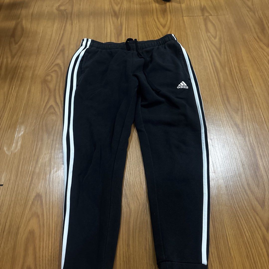 Adidas Black Joggers with White Stripes (Category: Other Bottoms) located in Quezon City. Submitted by murafindsph (Listing ID 1461299309, Image 2). Description: - Classic black Adidas joggers - Iconic white three stripes on sides - Elastic waistband with drawstring - Cuffed ankles - Ideal for casual wear or sports.