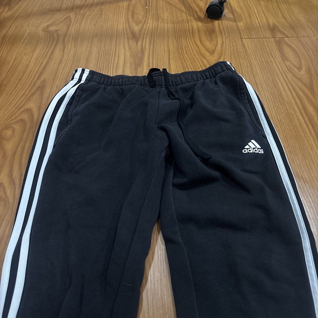 Adidas Black Joggers with White Stripes (Category: Other Bottoms) located in Quezon City. Submitted by murafindsph (Listing ID 1461299309, Image 3). Description: - Classic black Adidas joggers - Iconic white three stripes on sides - Elastic waistband with drawstring - Cuffed ankles - Ideal for casual wear or sports.