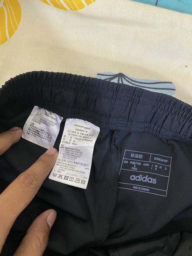 Adidas Black Track Pants Joggers Size M (Category: Joggers) located in Manila. Submitted by carbertjakosalem (Listing ID 1461311339, Image 3). Description: - Adidas Black Track Pants - Size: Medium (M) - Iconic Adidas logo - Reflective stripes on sides - Elastic waistband with drawstring for adjustable fit - Zippers at ankle for customizable leg opening - Ideal for workouts and casual wear.