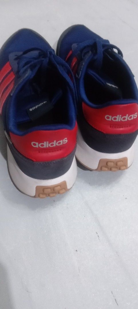 Adidas Blue and Red Sneakers (Category: Sneakers) located in Marikina City. Submitted by elenablinknini (Listing ID 1461320048, Image 3). Description: - Adidas sneakers in blue with red accents - Classic three stripes design - Lace-up closure for a secure fit - Durable rubber sole no flaws - Great for casual wear or light sports - Shows some signs of wear but still has plenty of life left.