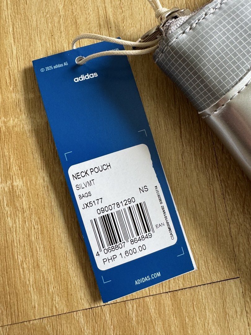 Adidas Neck Pouch Silver Metallic JX5177 (Category: Purses & Pouches) located in Manila. Submitted by helloseptembermnl (Listing ID 1461130001, Image 2). Description: - Brand: Adidas - Model: JX5177 - Color: Silver Metallic - Condition: Brand new with original tag - Features: Zip closure, ideal for carrying essentials - Design: Clean and minimalist.