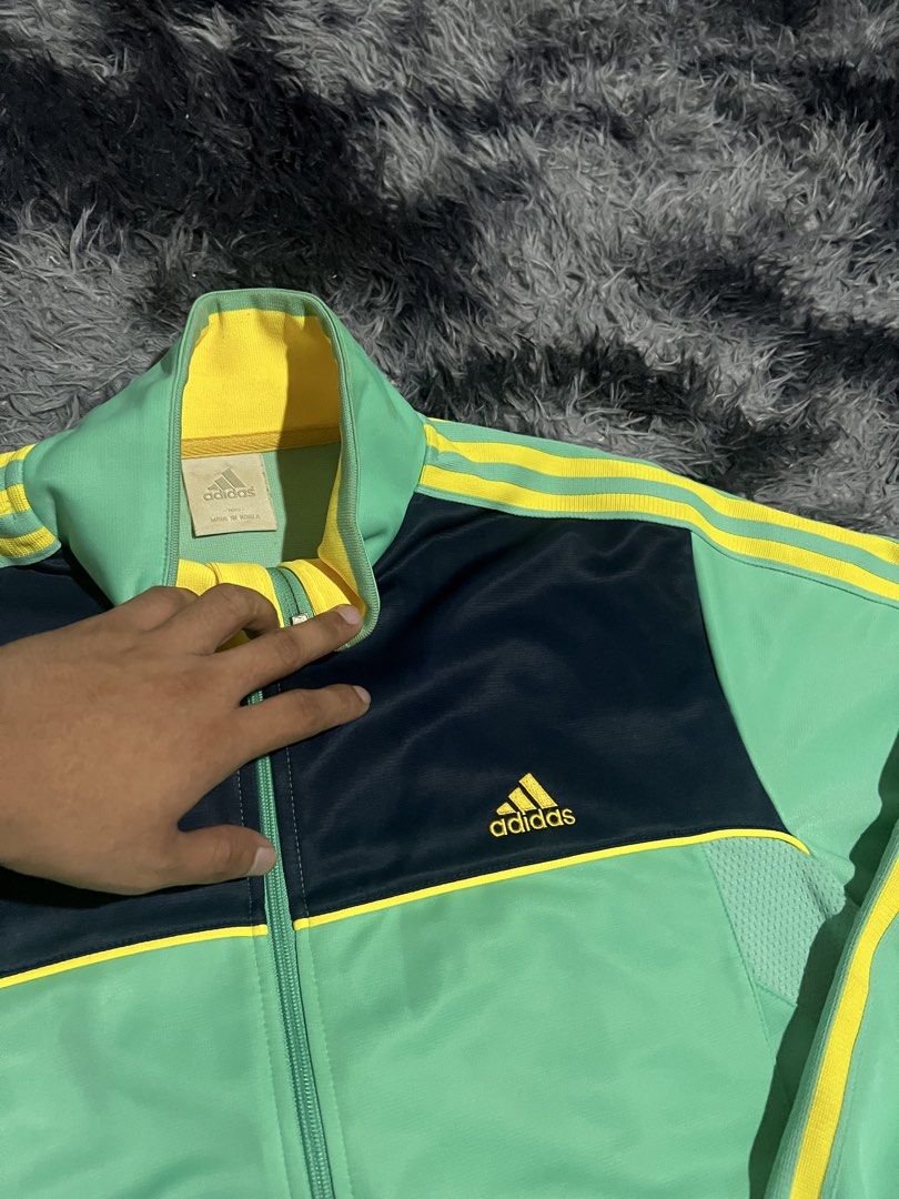 Adidas Track Jacket Green Yellow Navy (Category: Coats, Jackets and Outerwear) located in Cebu City. Submitted by drip_block (Listing ID 1461234332, Image 3). Description: Dimes 21x27 - Classic Adidas track jacket - Bright green main body - Navy blue chest panel - Iconic yellow three stripes on sleeves and shoulders - Yellow collar lining - Small tag detail on bottom right - Perfect for casual wear or sports activities.