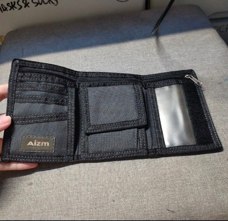 Aizm Camouflage Tri-Fold Wallet (Category: Wallets & Card Holders) located in Quezon City. Submitted by dncpreloved (Listing ID 1461148519, Image 2). Description: - Stylish camouflage tri-fold wallet - Black interior with multiple card slots - Clear ID window for easy access - Secure zippered coin pocket - Made from durable material for everyday use - Ample space for all your essentials.
