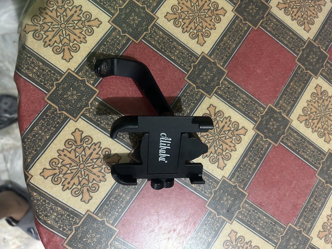 Alibaba Phone Holder Mount for Car/Desk (Category: Mounts & Holders) located in Manila. Submitted by ravereyes (Listing ID 1461192063, Image 2). Description: - Universal adjustable clamp fits most phones - Versatile mounting: Attaches to desk or car dashboard - 360° swivel arm for optimal viewing angle - Ideal for hands-free calls and GPS navigation - Sleek black design.