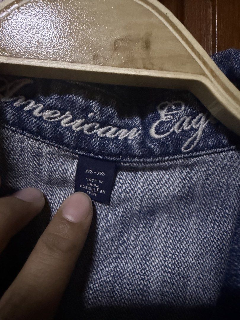 American Eagle Blue Denim Jacket (Category: Coats, Jackets and Outerwear) located in Pasig City. Submitted by aprilluxcloset0812 (Listing ID 1461292267, Image 2). Description: - Classic blue denim jacket from American Eagle - Button-up front - Two chest pockets - Distressed details on front and back - Ideal for layering - Versatile styling for any outfit RFS: decluttering EVERYTHING MUST GO‼️Just make a reasonable offer ❤️ All items ON HAND, hand