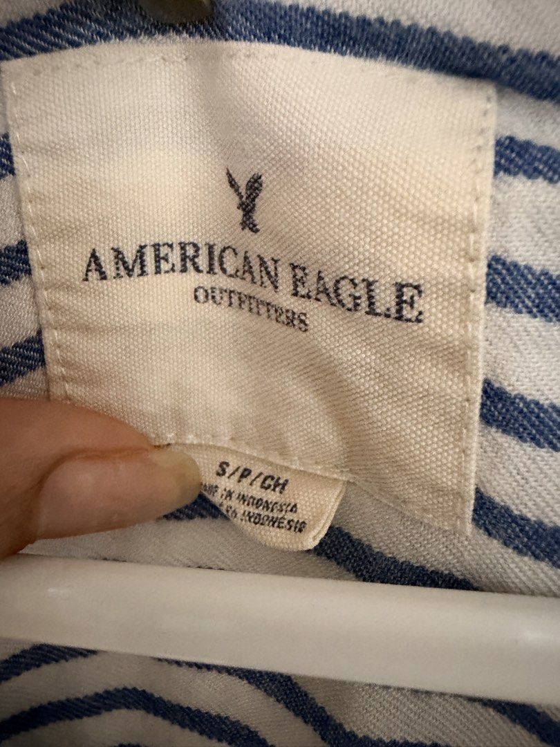 American Eagle Outfitters Striped Button-Up Shirt (Category: Shirts) located in Makati City. Submitted by ziagabrielle (Listing ID 1461142788, Image 3). Description: - Brand: American Eagle Outfitters - Color: Blue and white stripes - Style: Button-up shirt - Sleeves: Short with rolled cuffs - Features: Single chest pocket - Material: Lightweight - Occasion: Casual wear - Styling: Easy to pair with various outfits -W21xL29.