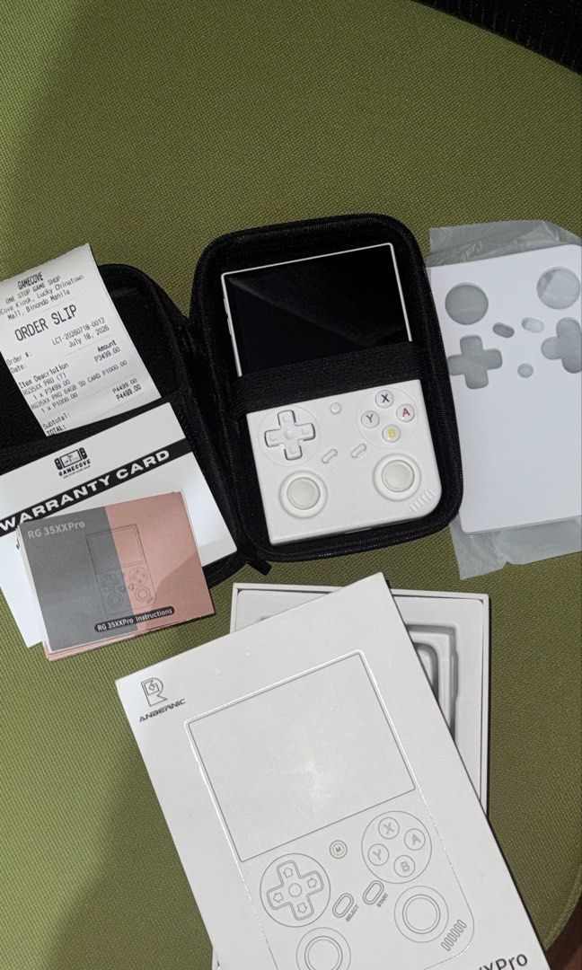 Anbernic RG35XXPro Handheld Game Console White (Category: Others) located in Pasig City. Submitted by goodbuy_02 (Listing ID 1461317885, Image 3). Description: - Anbernic RG35XX Pro (White) - Original box, warranty card, and order slip included - Purchased on July 18, 2023 - Comes with a 64GB SD card - Ready for your retro gaming adventures!.