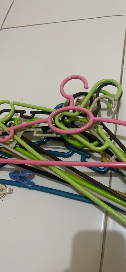 Assorted Plastic Clothes Hangers Bundle (Category: Hooks & Hangers) located in Manila. Submitted by jana0011 (Listing ID 1461255548, Image 1). Description: - Bundle of assorted plastic clothes hangers - Includes various colors: pink, green, blue, and brown - Some hangers come with clips attached - Ideal for organizing shirts, dresses, and pants - Great for decluttering your wardrobe - Sold as a lot.