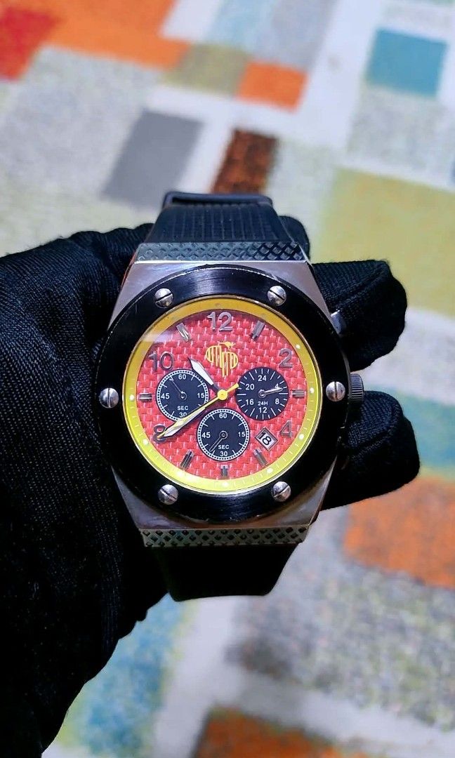 Aust- Phils Chronograph Watch with Red Dial and Yellow Bezel (Category: Luxury Watches) located in Baliuag. Submitted by marieannfernando23 (Listing ID 1461287135, Image 2). Description: - Men's Watch Cool chronograph watch - Red textured dial with yellow accents - Three subdials for stopwatch functions - Date window included - Black bezel with silver screws - Comes with a black strap - Ideal for everyday wear or collectors - Like new .
