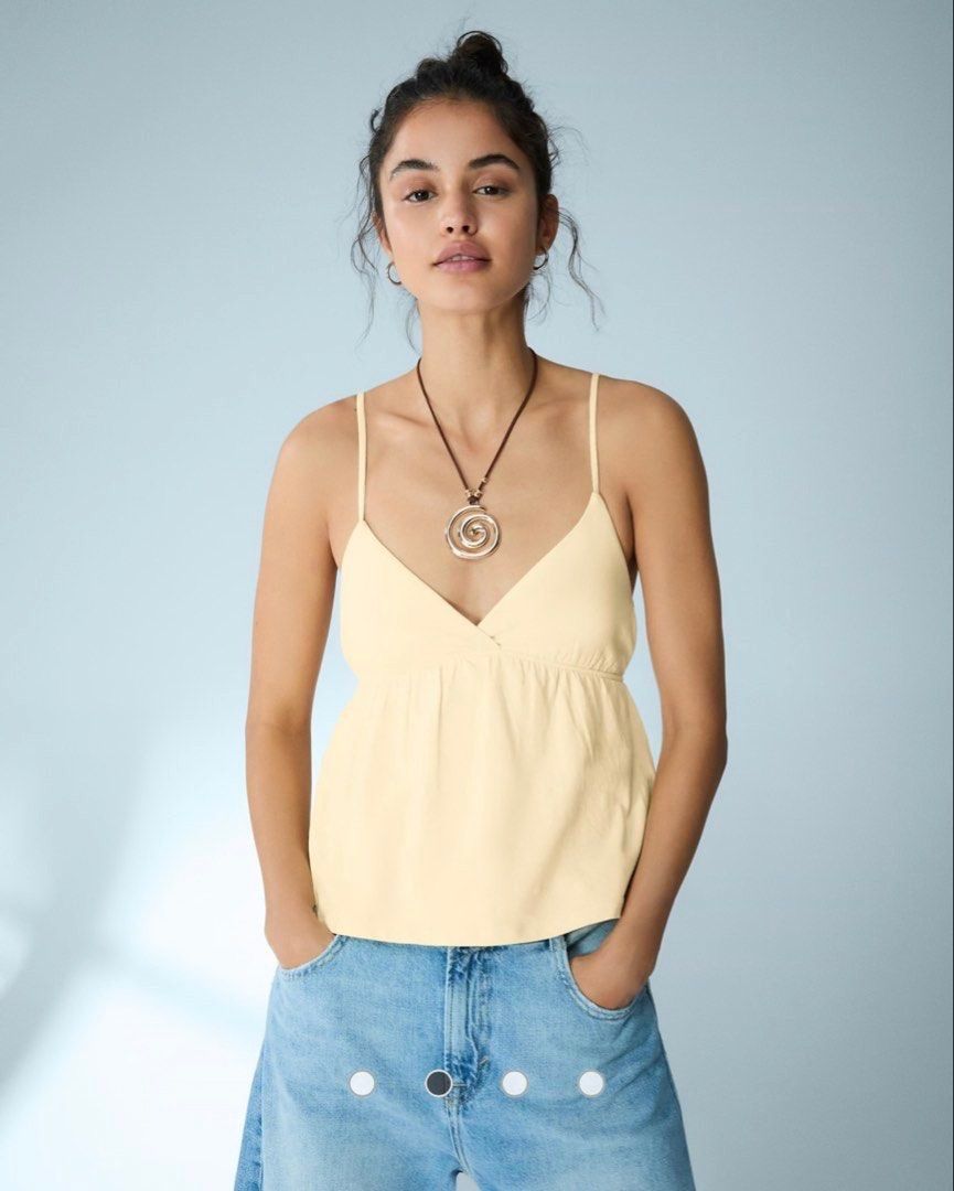Authentic Bershka Butter Yellow Cami Top (Category: Sleeveless) located in Quezon City. Submitted by tacocat888 (Listing ID 1461286279, Image 3). Description: !! Has minor defect at the back (see photo posted) - Size XS - Brand new (minor defect) - Cute & dainty butter yellow summer top - High quality and light fabric with stretchy back - Chic style 📍 QC Shipping fee will be shouldered by the buyer..