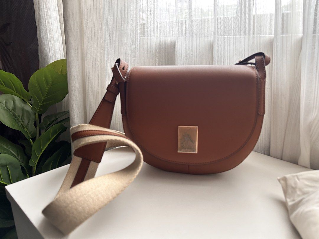 Authentic Couronne Leather Saddle Bag - Brown (Category: Luxury Bags & Wallets) located in Santa Rosa. Submitted by jolels (Listing ID 1461119128, Image 2). Description: - Genuine brown leather saddle bag by Couronne. - Bought from South Korea still comes with receipt. -Bought for USD194 (Php 12k+) - Comes with original dust bag and packaging. - Elegant gold accent on the front but with tarnish and scratches due as signs of use. -Inside gold plat