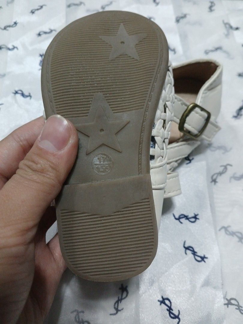 Baby Sandals (Category: Babies & Kids Fashion) located in La Trinidad. Submitted by dashopperist (Listing ID 1461226269, Image 2). Description: - Adorable white baby shoes - Features a charming woven design on the front - Secure buckle strap for a comfortable fit - Fun star pattern on the sole - Perfect for your little one!.