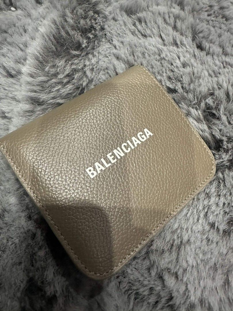 Balenciaga Leather Bifold Wallet (Category: Luxury Bags & Wallets) located in Mandaluyong City. Submitted by calibre915 (Listing ID 1461153993, Image 1). Description: - Authentic Balenciaga bifold wallet - Chic taupe leather - Multiple card slots for organization - Secure coin pocket with snap closure - Subtle embossed Balenciaga logo on the front - Immaculate interior condition - Ideal for everyday essentials.