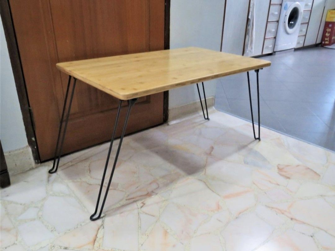 Bamboo top foldable table (Category: Tables & Sets) located in Singapore. Submitted by townerfriends (Listing ID 1461240708, Image 2). Description: Brand New High quality bamboo top [2cm thickness] Unique design laptop / study / breakfast in bed table Foldable hairpin legs Fold in seconds, just squeeze both sides of leg to unlock [see pic 4] Very portable and space saving Withstanding weight: 80kg Rust resistant and peel resistant legs Dimension 