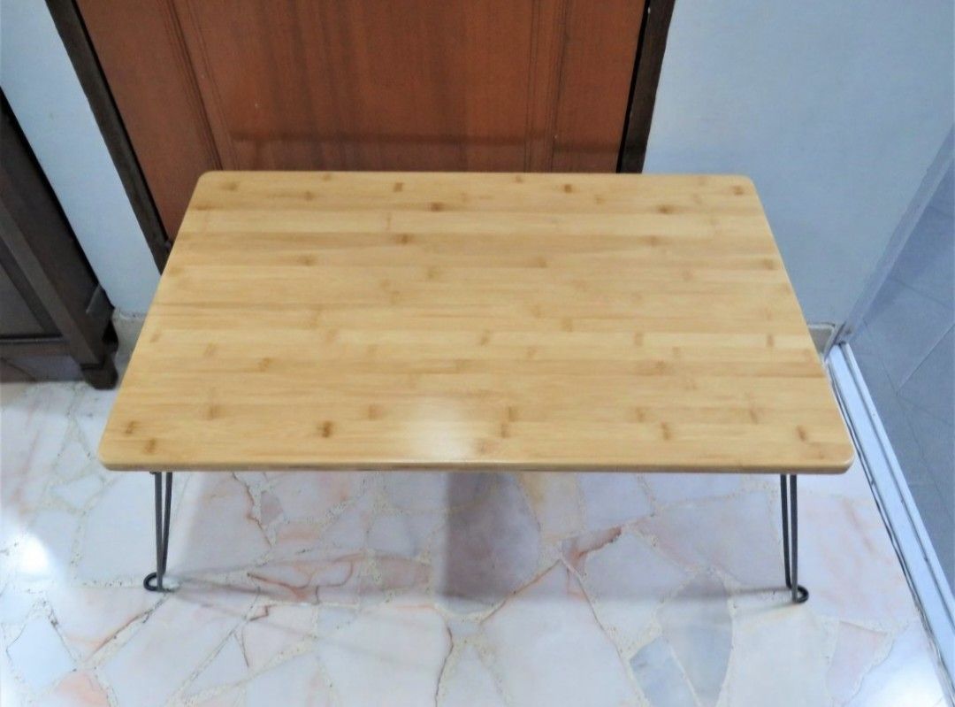 Bamboo top foldable table (Category: Tables & Sets) located in Singapore. Submitted by townerfriends (Listing ID 1461240708, Image 3). Description: Brand New High quality bamboo top [2cm thickness] Unique design laptop / study / breakfast in bed table Foldable hairpin legs Fold in seconds, just squeeze both sides of leg to unlock [see pic 4] Very portable and space saving Withstanding weight: 80kg Rust resistant and peel resistant legs Dimension 