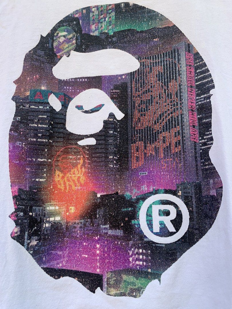 BAPE City Camo Ape Head Tee White (Category: Tshirts & Polo Shirts ) located in Aloran. Submitted by chester78864 (Listing ID 1461285370, Image 3). Description: - White BAPE T-shirt -stain issue and minor flaw on print - Iconic Ape Head graphic with city skyline print - Graphic on both front and back - Size: Medium (M) - Essential for any streetwear collection.