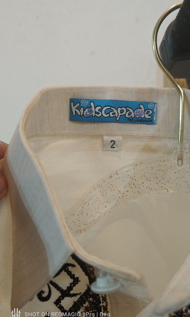 Barong for Kids (Category: Babies & Kids Fashion) located in Manila. Submitted by dentoters (Listing ID 1461135508, Image 3). Description: Measurements: Length - 40cm Width (shoulders) - 30cm Sleeve length - 38cm Description: - Cream-colored Barong Tagalog shirt for boys age 3-4 years old. Features intricate brown and black embroidery on the chest. - Long sleeves with button cuffs. Made from a light, slightly sheer fabric. Ideal for formal events