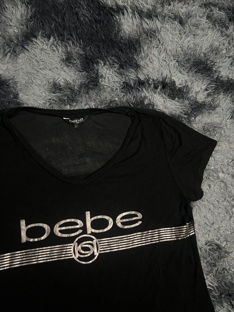 Bebe Black TShirt with Logo Graphic (Category: Shirts) located in Cebu City. Submitted by drip_block (Listing ID 1461231987, Image 3). Description: Dimes 17x25 Cut washtag - Brand: Bebe - Color: Black - Features: Bebe logo across chest with striped detail - Material: Soft fabric - Fit: Comfortable - Occasion: Casual wear.