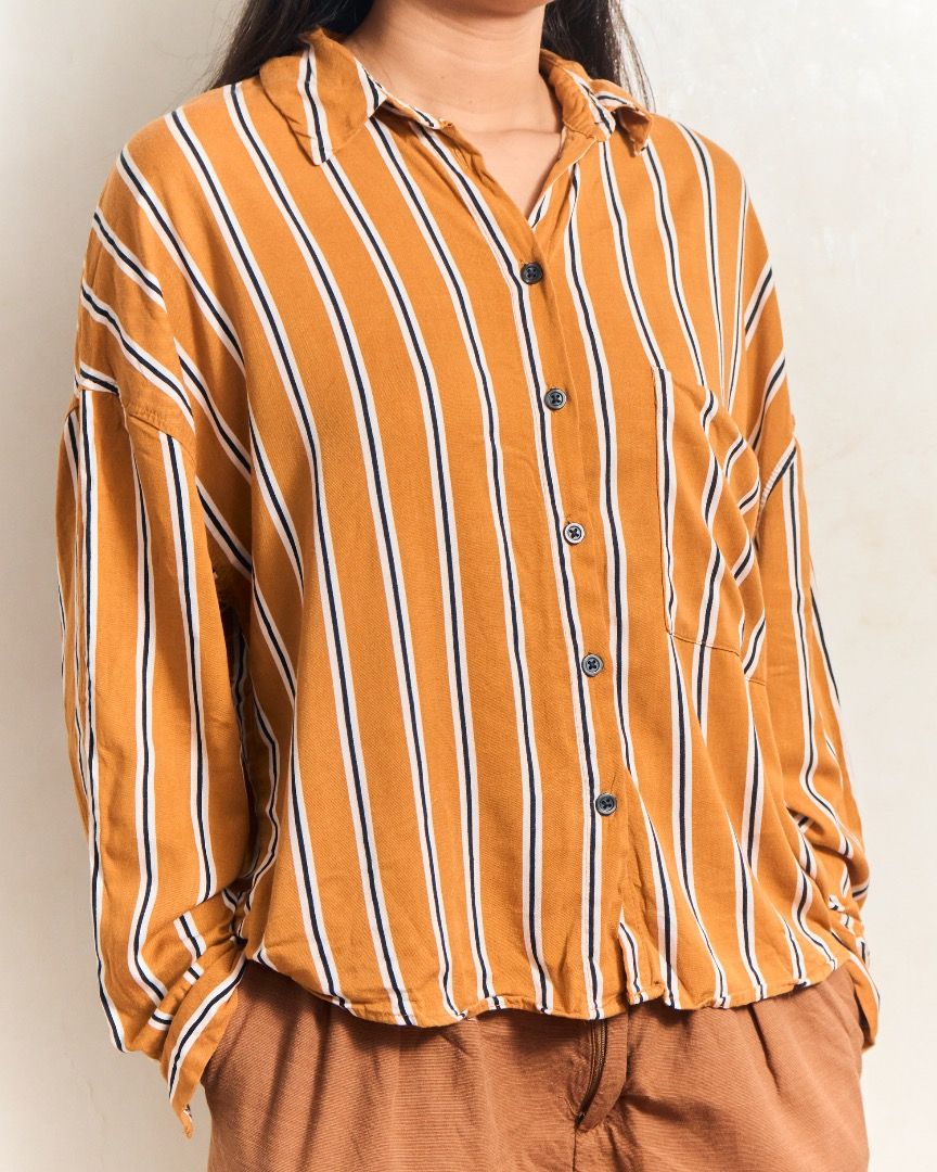 Bershka Striped Button-Up Shirt (Category: Shirts) located in Manila. Submitted by missalmon (Listing ID 1461254669, Image 1). Description: L: 17 inches W: 23.5 inches Loose fit Square fit Striped With 1 pocket .