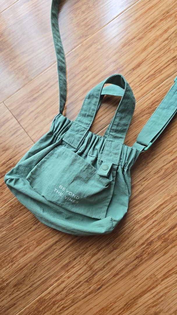 Beyond The Vines Micro Dumpling Bag (Category: Tote Bags) located in Paranaque City. Submitted by monicaher (Listing ID 1461118423, Image 1). Description: Beyond The Vines green tote bag. Adjustable straps, front snap pocket. Textured fabric, good for daily use..