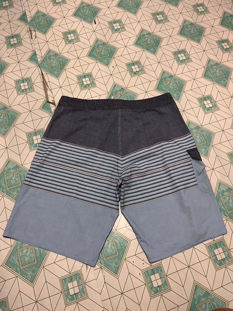 Billabong Striped Board Shorts (Category: Swim Trunks & Board Shorts) located in Manila. Submitted by _lemornosnas02 (Listing ID 1461153458, Image 3). Description: - Brand: Billabong - Style: Board Shorts - Color: Blue and Grey striped pattern - Features: Back velcro pocket with Billabong logo, drawstring waist for adjustable fit - Ideal for: Swimming, lounging, beach activities -location iloilo -plus ship via lbc.