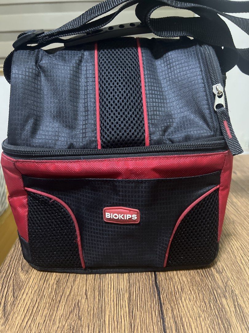 Biokips Insulated Cooler Bag (Category: Storage Boxes & Baskets) located in Quezon City. Submitted by lucky876 (Listing ID 1461238779, Image 1). Description: - Biokips Cooler Bag in Black and Red - Insulated interior to keep contents cool - Spacious main compartment - Convenient front pocket for essentials - Side mesh pockets for bottles or other items - Secure zipper closure - Adjustable shoulder strap for comfortable carrying - Ideal for picnic