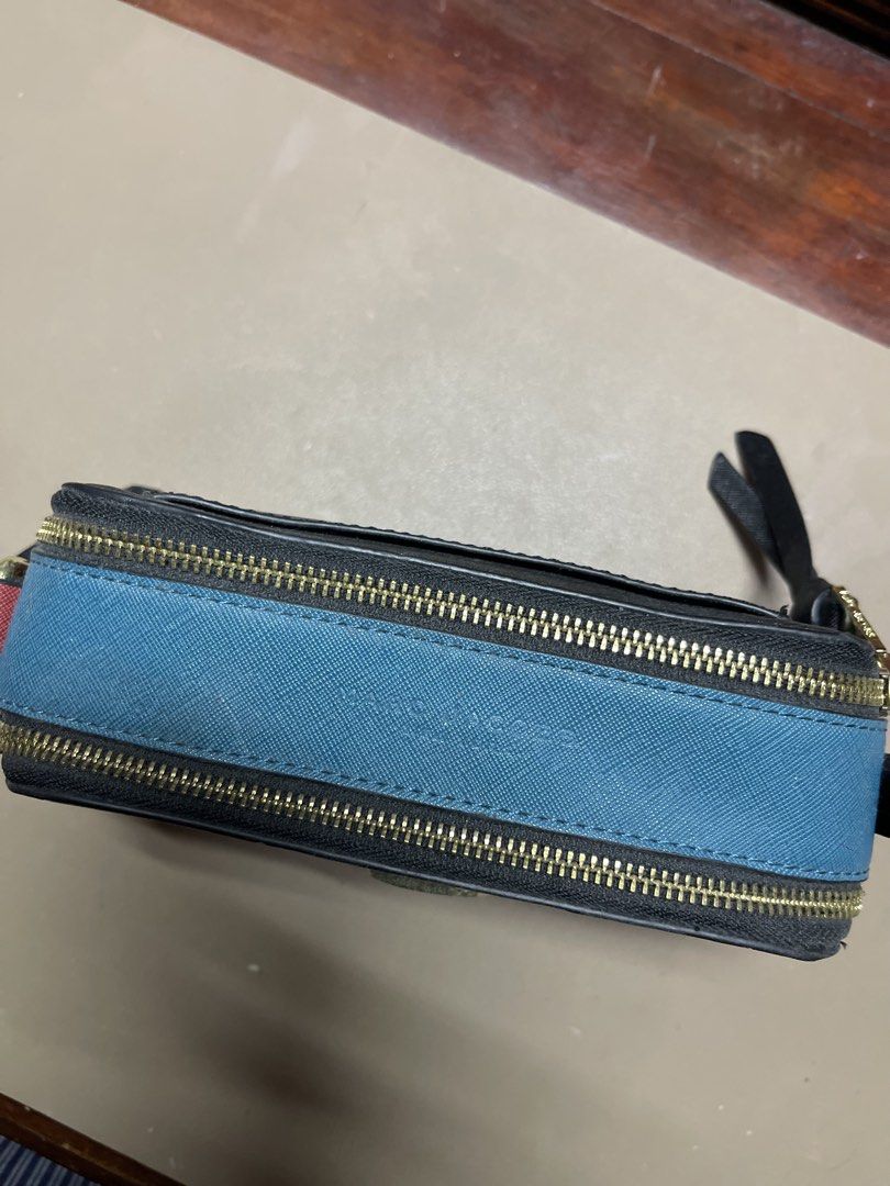 Black & Red Marc Jacobs Snapshot Pouch (Category: Luxury Bags & Wallets) located in Cainta. Submitted by d3clutterw0rld (Listing ID 1461301487, Image 2). Description: - Black saffiano leather pouch - Red trim detail - Gold Marc Jacobs logo on front - Double zip closure - Blue interior lining - Small strap with tassel detail - Note: Slight wear on the strap end - Ideal for cards, cash, or small essentials.