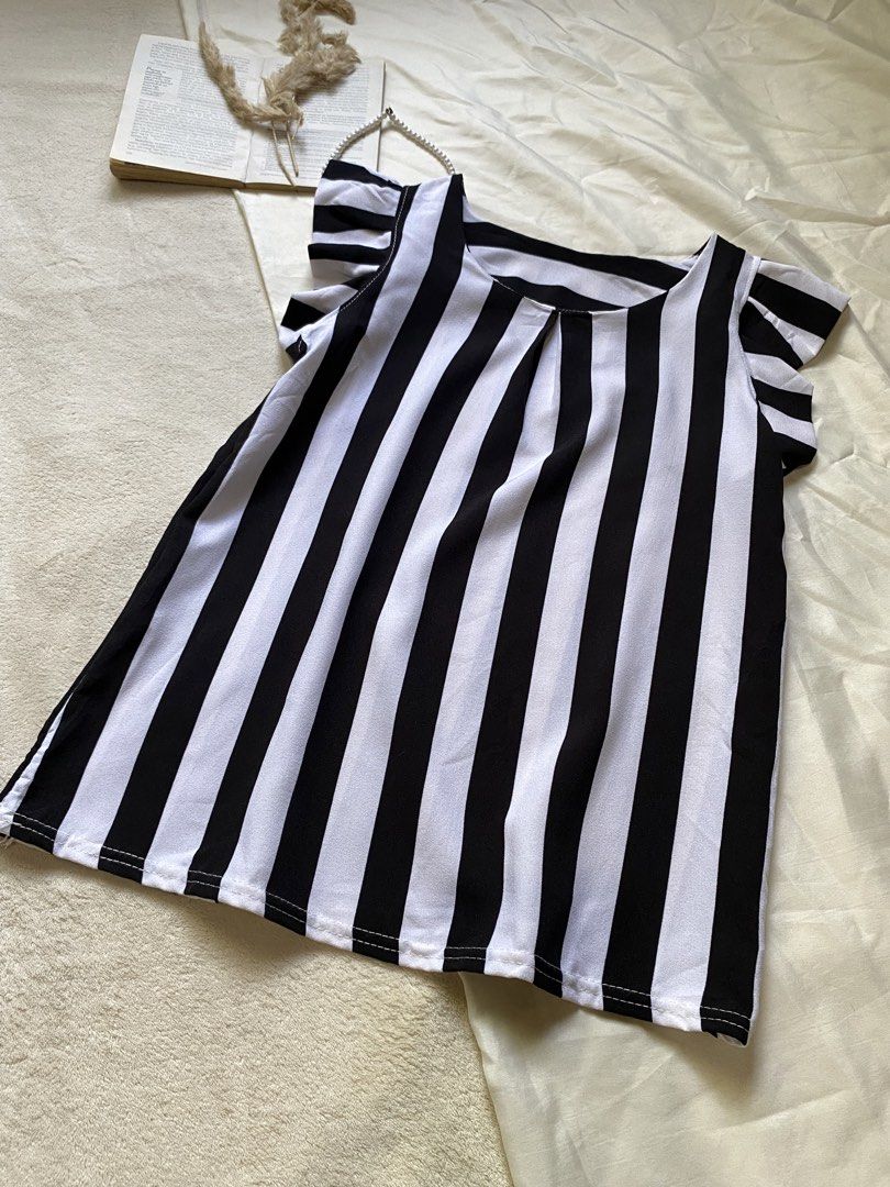 Black and White Striped Top with Flutter Sleeves Small 34 (Category: Blouses) located in Poro. Submitted by joyceyuu (Listing ID 1461303309, Image 2). Description: - Cute black and white striped top - Features flutter sleeves for added flair - Simple scoop neckline - Made of light and breezy fabric - Ideal for casual wear - Easily pairs with jeans or shorts.