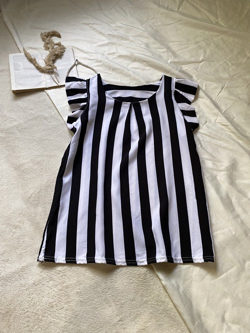 Black and White Striped Top with Flutter Sleeves Small 34 (Category: Blouses) located in Poro. Submitted by joyceyuu (Listing ID 1461303309, Image 1). Description: - Cute black and white striped top - Features flutter sleeves for added flair - Simple scoop neckline - Made of light and breezy fabric - Ideal for casual wear - Easily pairs with jeans or shorts.