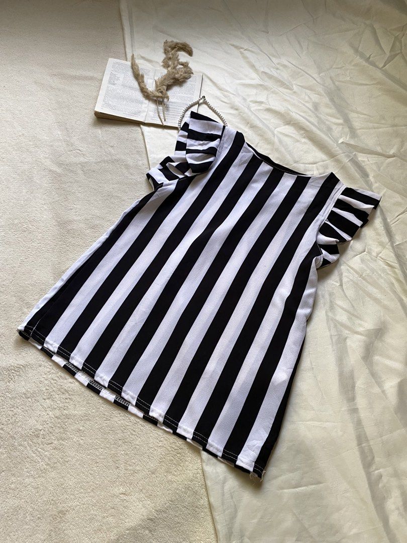 Black and White Striped Top with Flutter Sleeves Small 34 (Category: Blouses) located in Poro. Submitted by joyceyuu (Listing ID 1461303309, Image 3). Description: - Cute black and white striped top - Features flutter sleeves for added flair - Simple scoop neckline - Made of light and breezy fabric - Ideal for casual wear - Easily pairs with jeans or shorts.